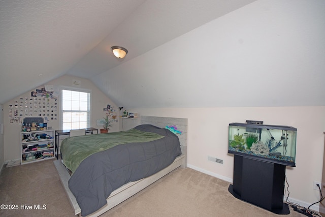 carpeted bedroom with lofted ceiling