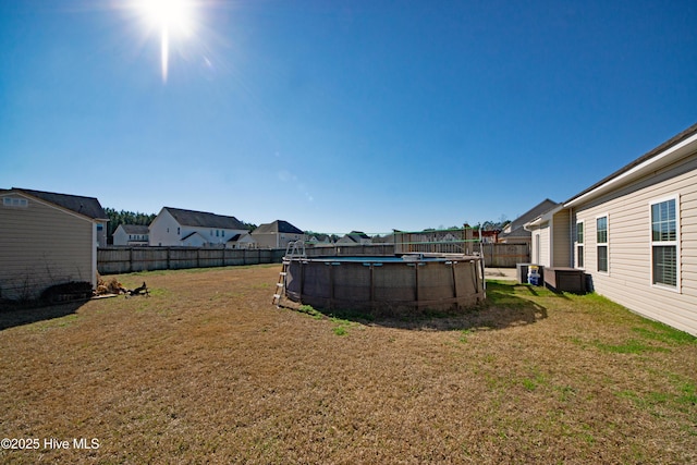 view of yard with a fenced in pool