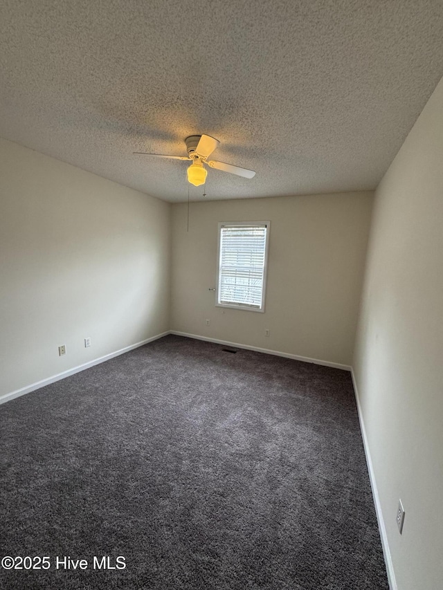 carpeted spare room with ceiling fan and a textured ceiling