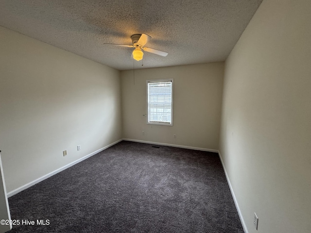 carpeted empty room featuring ceiling fan and a textured ceiling