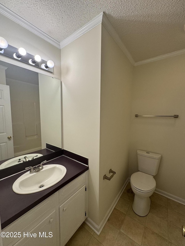 bathroom with vanity, ornamental molding, toilet, and a textured ceiling