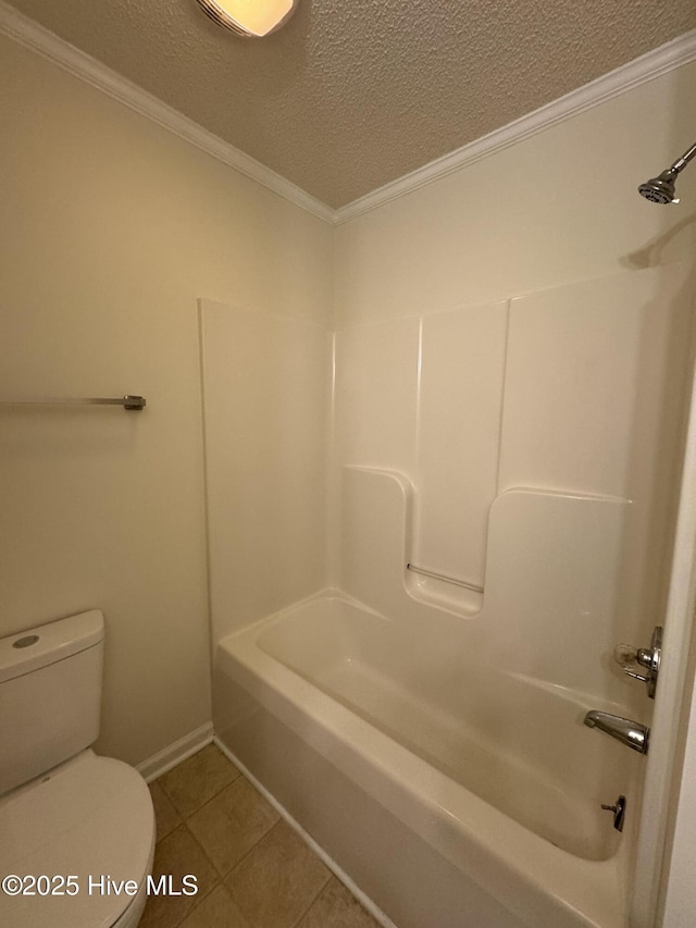 bathroom with crown molding, toilet, bathing tub / shower combination, tile patterned floors, and a textured ceiling