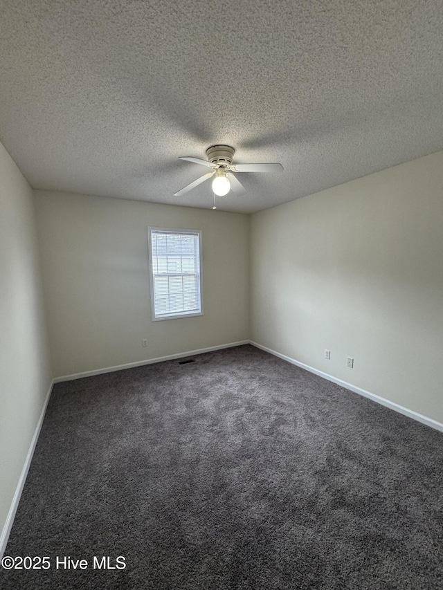 carpeted empty room featuring ceiling fan and a textured ceiling