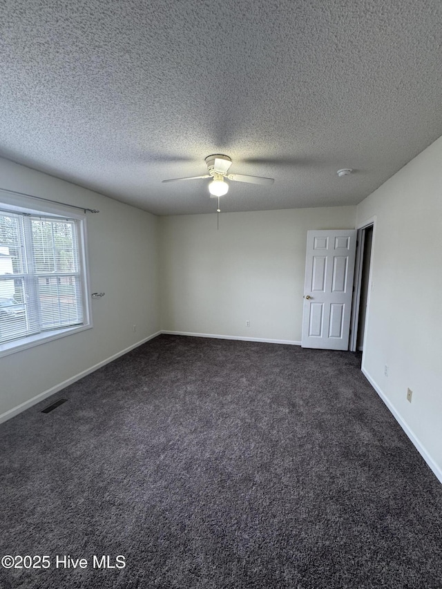 carpeted empty room with a textured ceiling and ceiling fan