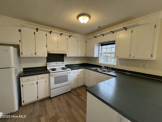 kitchen featuring white cabinets and white appliances