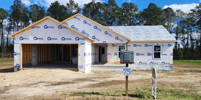 property under construction featuring dirt driveway and an attached garage