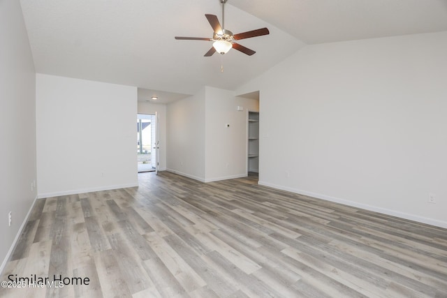 spare room with lofted ceiling, baseboards, ceiling fan, and light wood finished floors