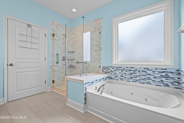 full bathroom featuring a jetted tub, tile patterned flooring, and a marble finish shower