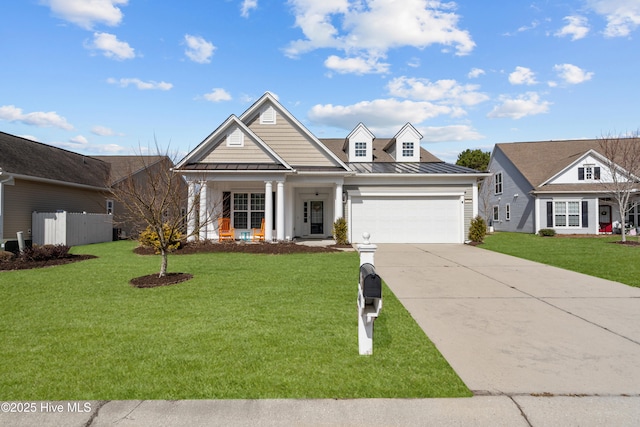 view of front of property with a garage, a front yard, a standing seam roof, and concrete driveway