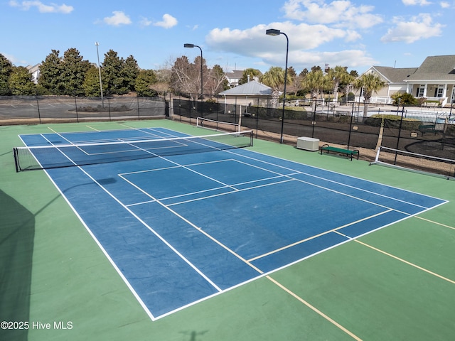 view of sport court with fence