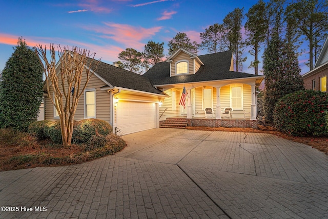 view of front of house with a garage and covered porch