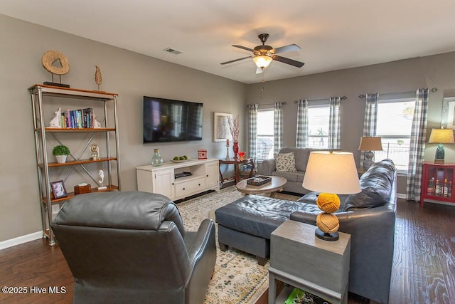 living room with dark wood-type flooring and ceiling fan