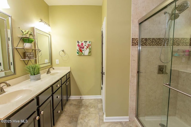 bathroom featuring vanity, tile patterned floors, and walk in shower