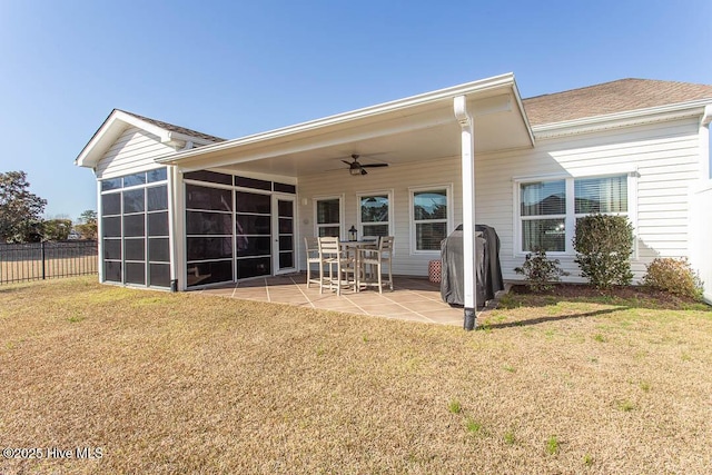 back of house with a patio, a sunroom, a yard, and ceiling fan