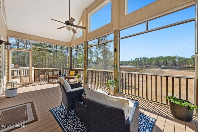 sunroom featuring lofted ceiling and ceiling fan