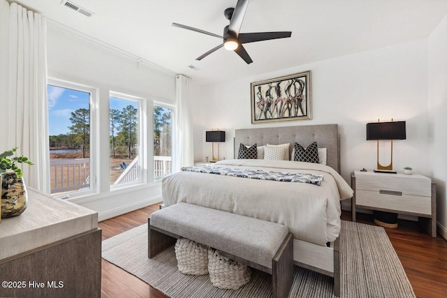 bedroom with visible vents, baseboards, ceiling fan, and wood finished floors