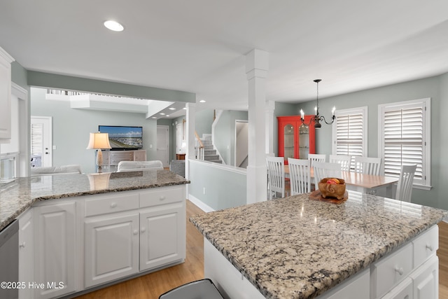 kitchen with white cabinets, dishwasher, light wood-style flooring, an inviting chandelier, and recessed lighting