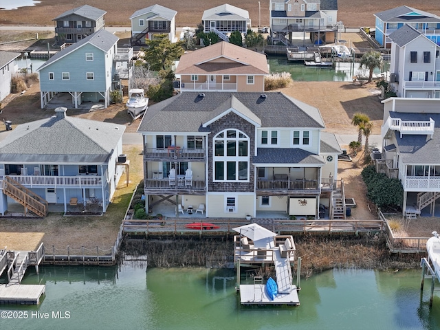 birds eye view of property featuring a water view and a residential view