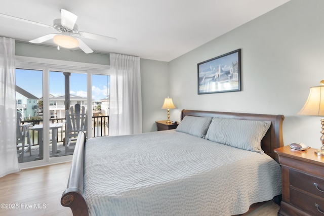 bedroom with access to exterior, a ceiling fan, and wood finished floors