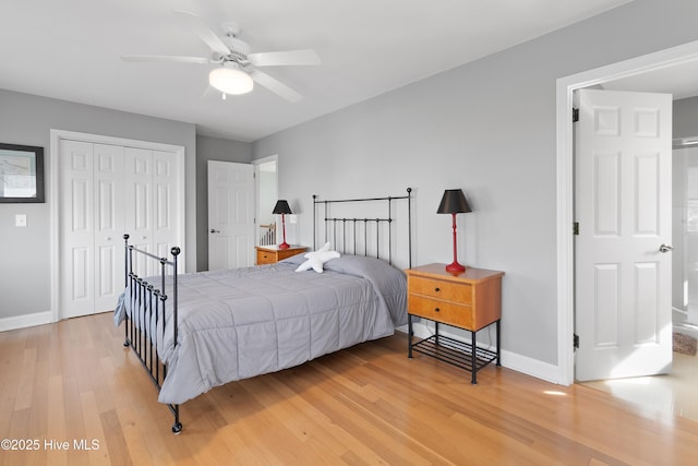 bedroom featuring a ceiling fan, light wood-type flooring, a closet, and baseboards