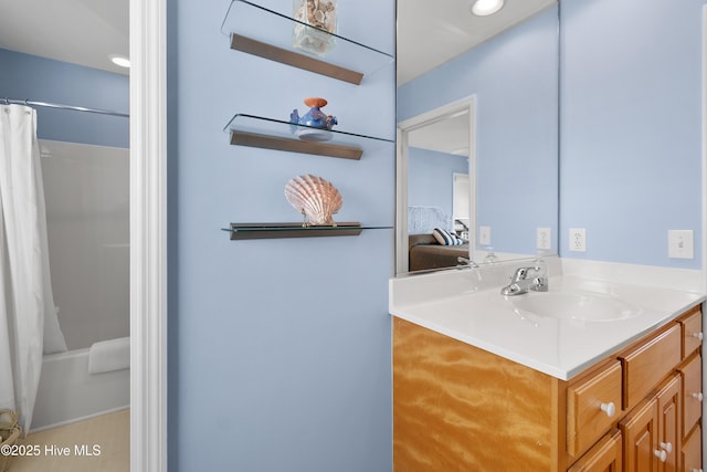 ensuite bathroom featuring a shower with curtain, ensuite bath, and vanity