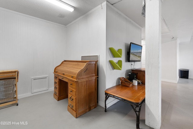 office area featuring concrete flooring and crown molding