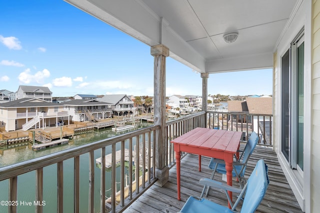 balcony with a water view and a residential view