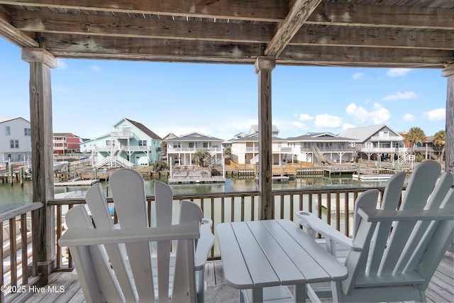 wooden deck with a boat dock, a water view, and a residential view