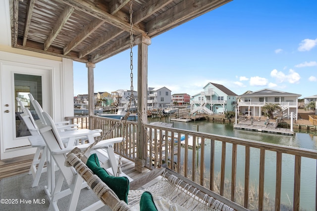 balcony featuring a water view and a residential view