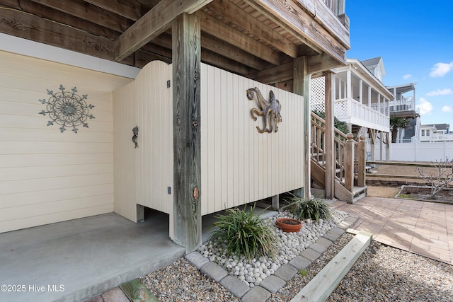 view of side of property featuring stairway