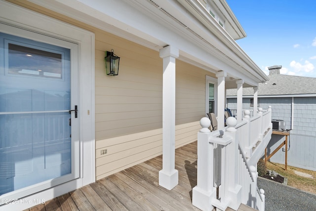 wooden deck with central air condition unit