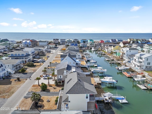 drone / aerial view featuring a residential view and a water view