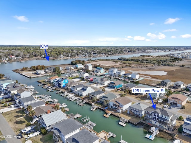 birds eye view of property with a water view and a residential view