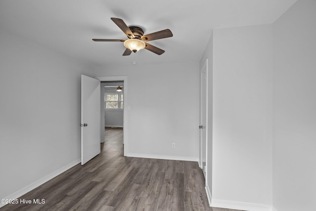 empty room featuring ceiling fan and dark hardwood / wood-style floors