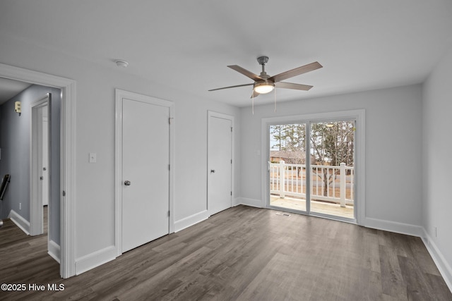 unfurnished bedroom featuring dark wood-type flooring, ceiling fan, and access to exterior