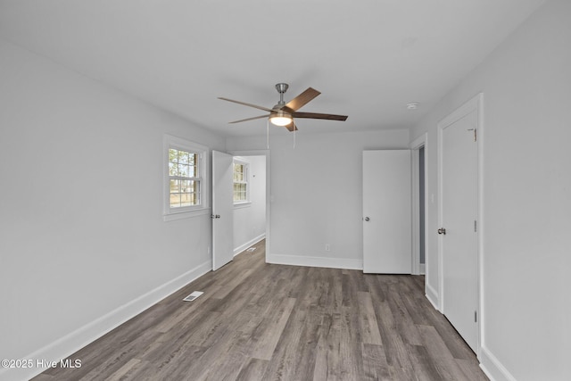 spare room featuring hardwood / wood-style floors and ceiling fan