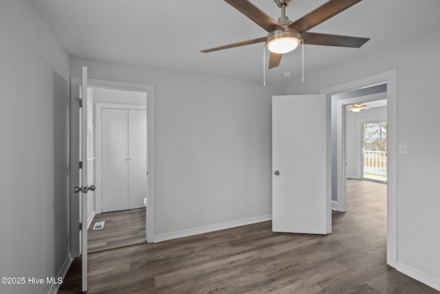 unfurnished room with ceiling fan and dark hardwood / wood-style flooring