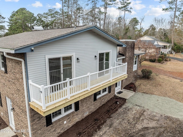 back of property with a balcony