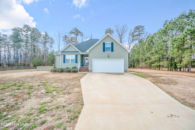 view of front of property featuring driveway and fence