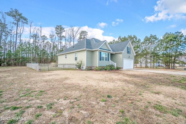 view of property exterior with a garage, concrete driveway, and fence