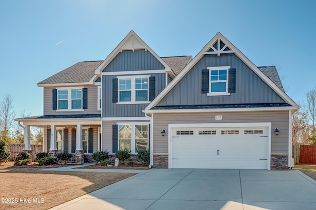 craftsman inspired home featuring a garage and covered porch