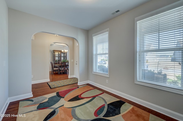 interior space featuring a chandelier and dark hardwood / wood-style flooring