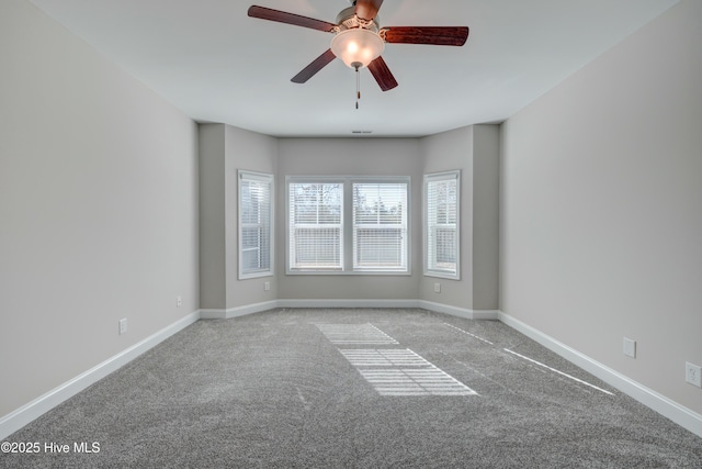 spare room with ceiling fan and light carpet