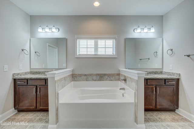 bathroom with vanity, tile patterned floors, and a tub