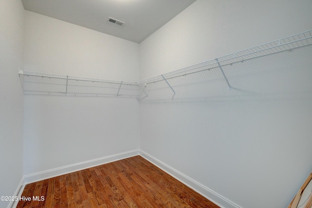 spacious closet featuring hardwood / wood-style flooring