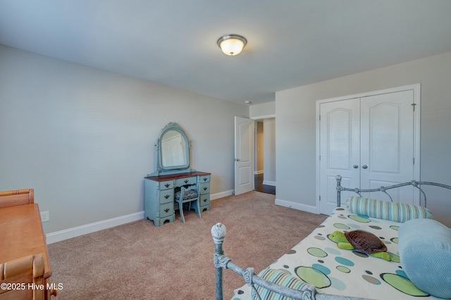 bedroom with light carpet and a closet