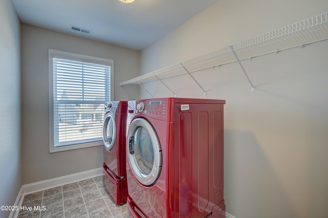 clothes washing area with washer and dryer