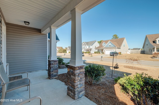 view of patio with a garage and covered porch