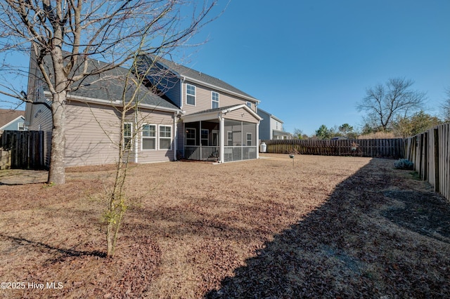 back of house featuring a sunroom