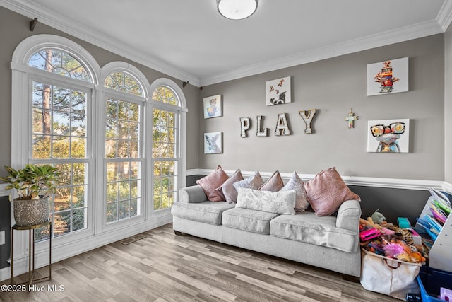 living room with hardwood / wood-style flooring and crown molding